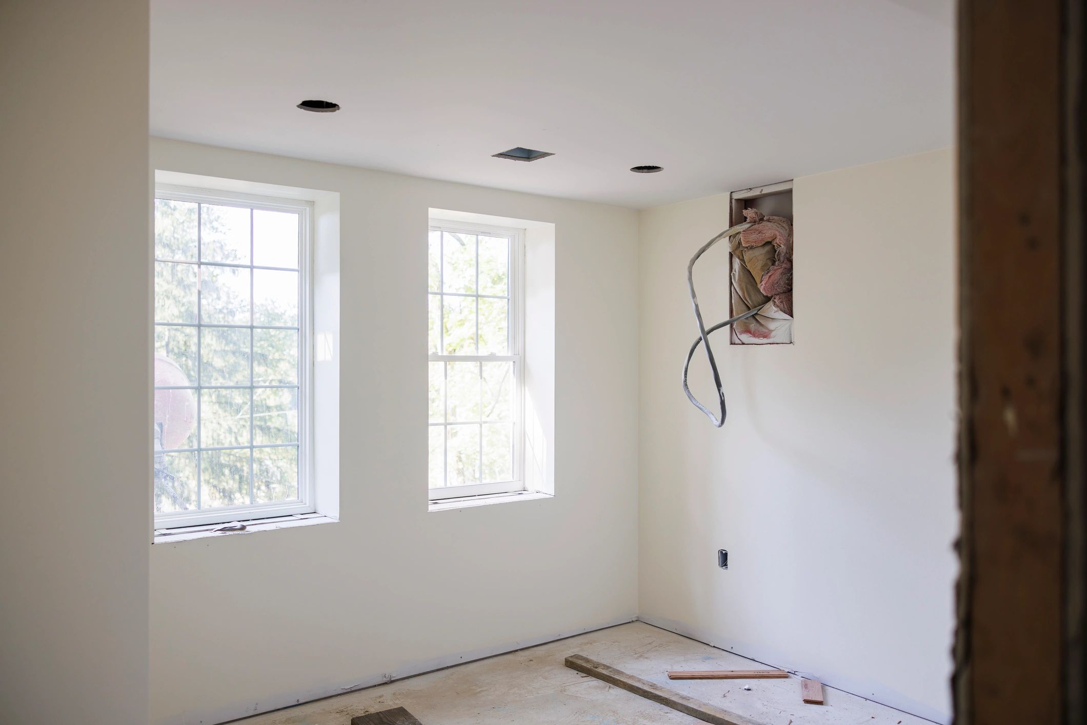 Renovated room in progress with bright windows